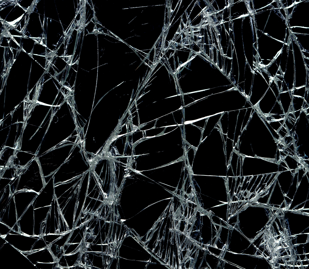 Broken glass over black background