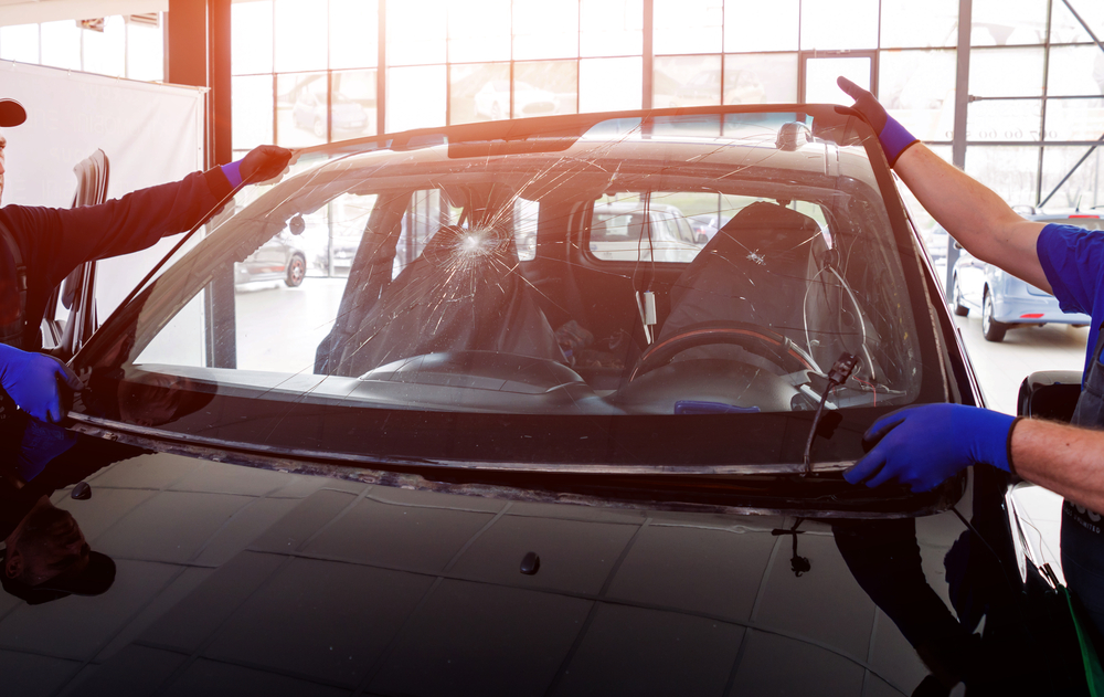 men replacing an auto windshield